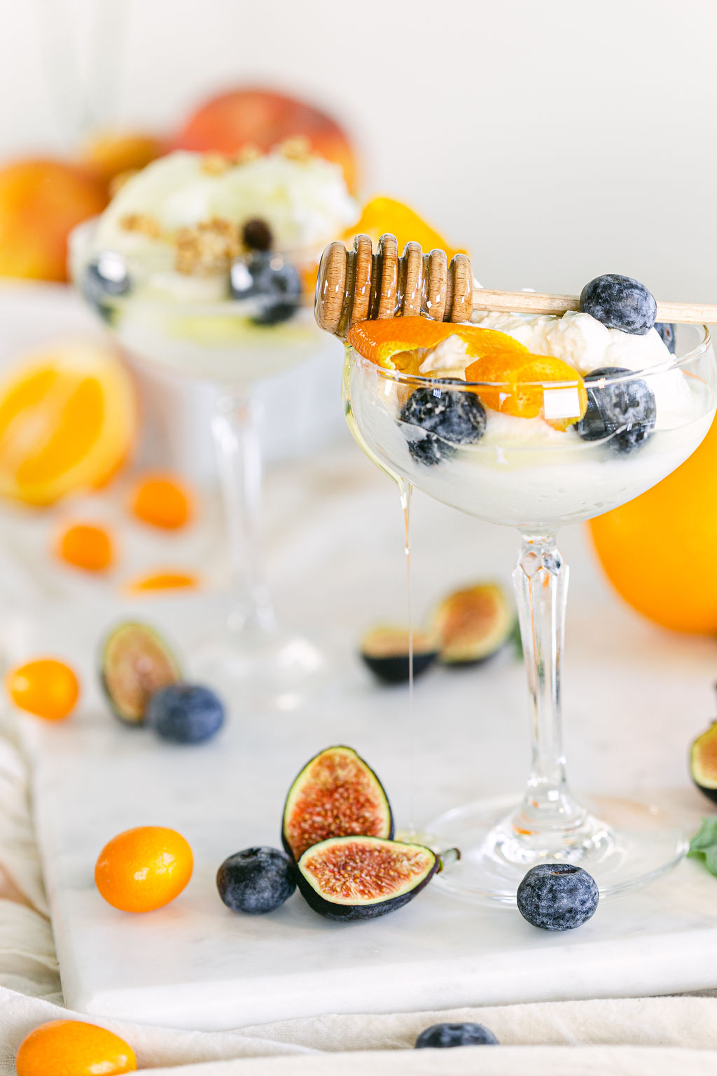 Luxe yogurt parfait in champagne coupe wine glass with blueberries and kumquats styled food photography San Diego by Chelsea Loren
