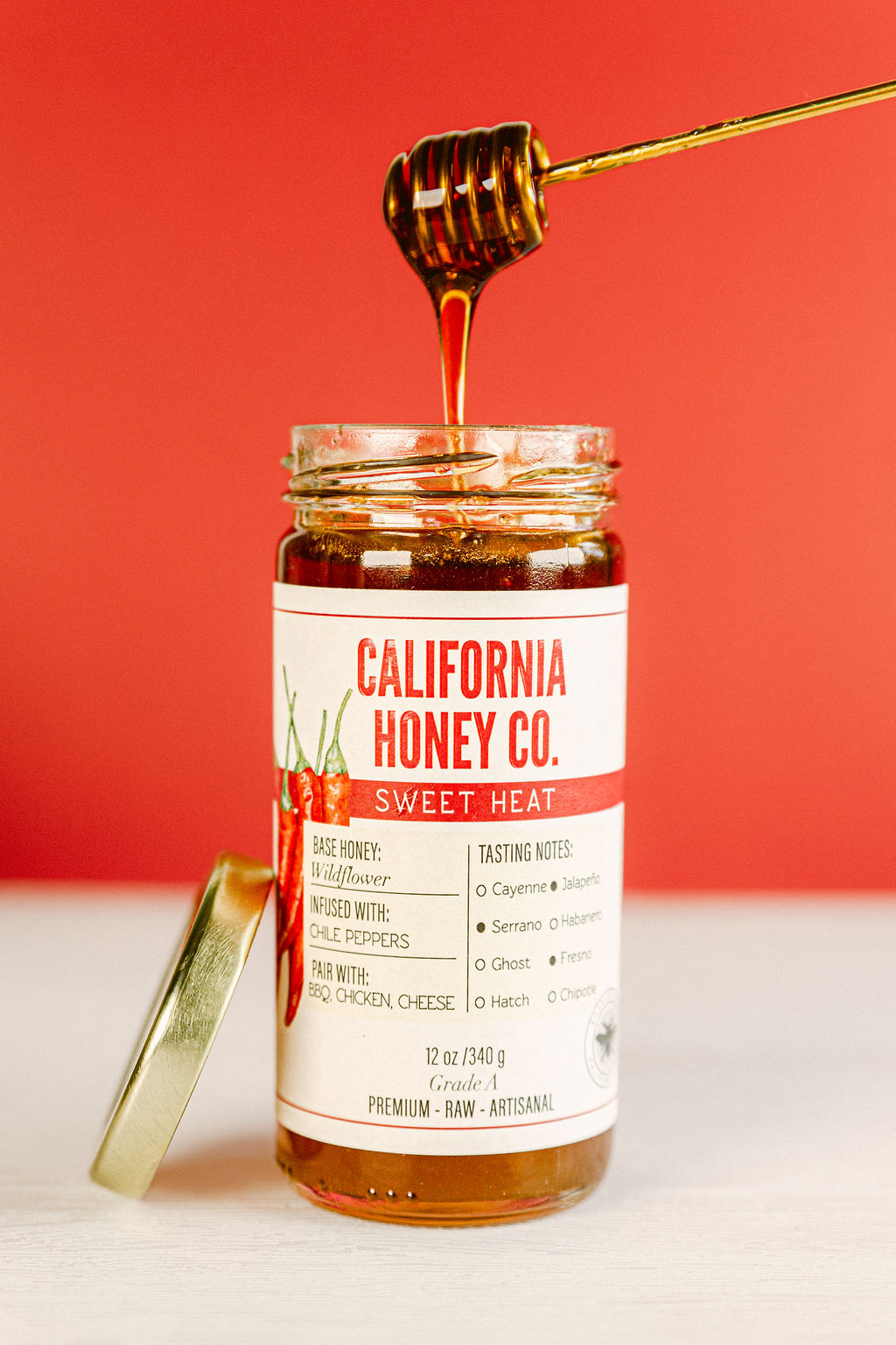 San Diego product food photographer with honey and dripper drizzling honey unique product imagery farmers market food