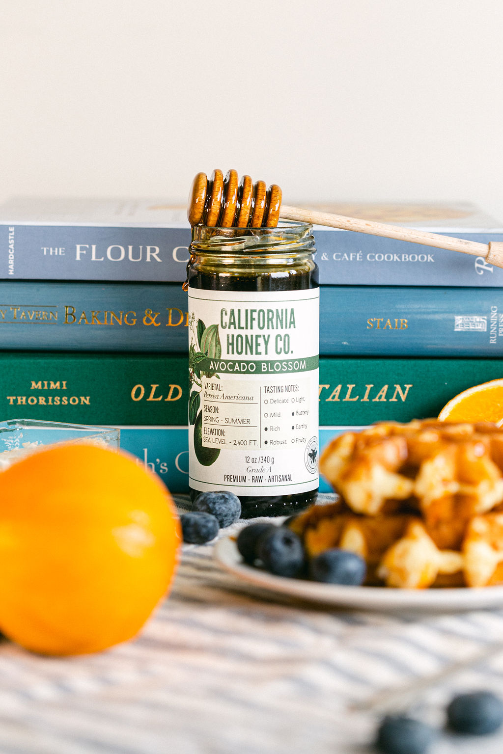 Lifestyle food photography featuring cookbooks cottage baking waffles with honey by Chelsea Loren San Diego product food photographer