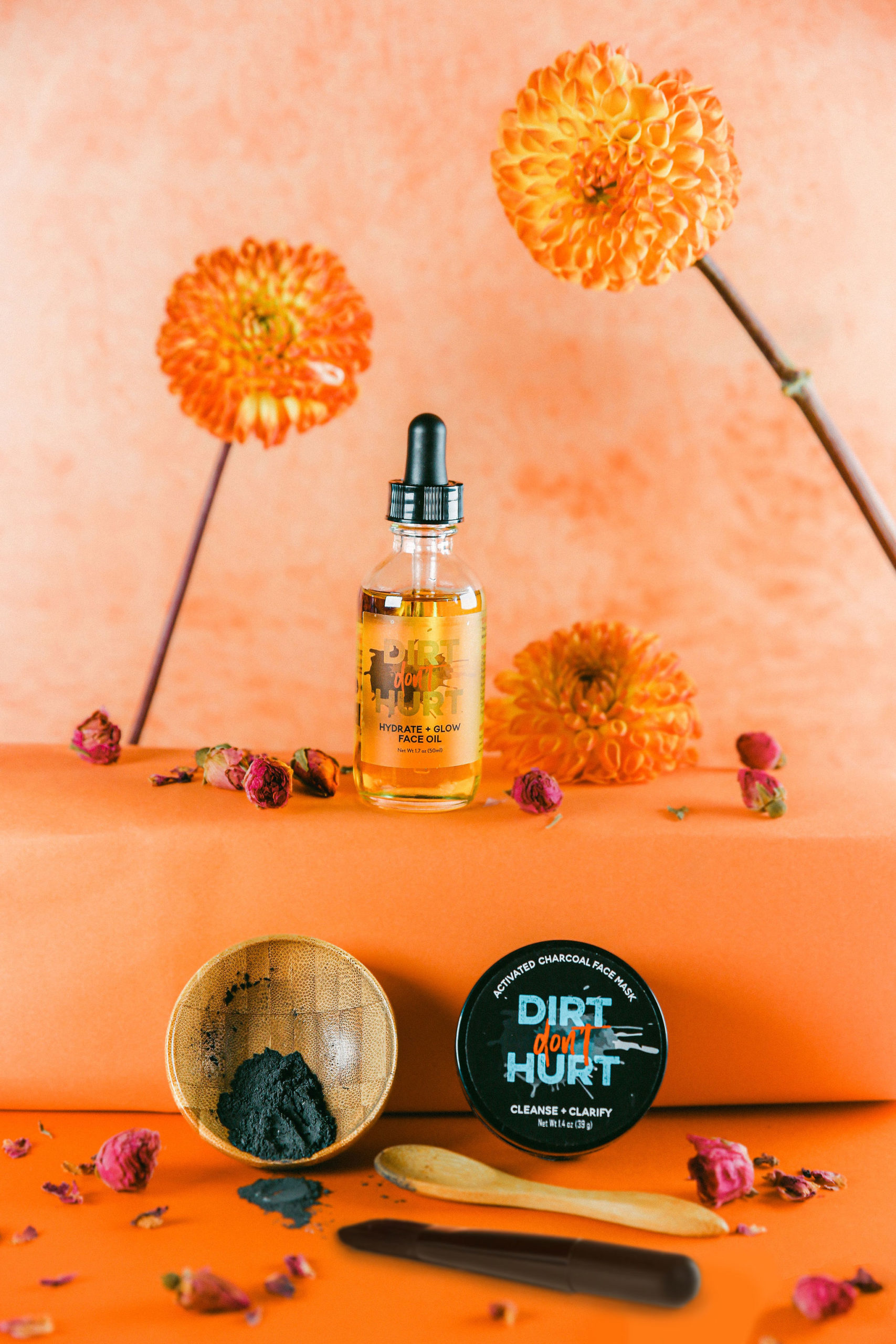 styled skincare product photography funky bright orange dahlias black owned small business how to style skincare etsy