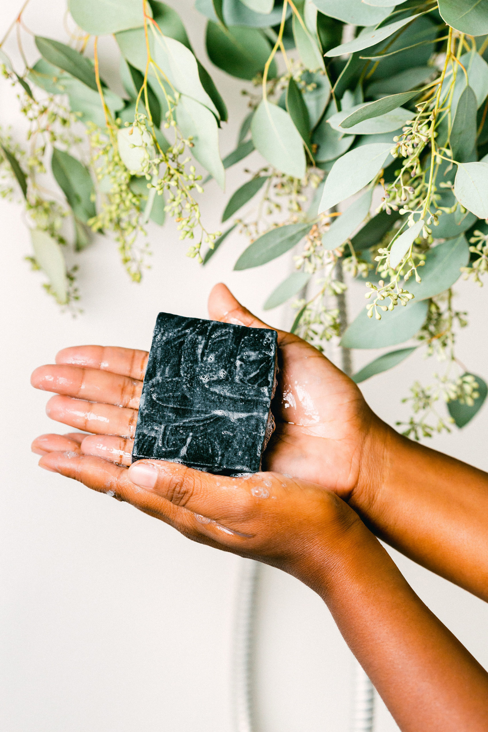 Charcoal soap styled product photography small business lathered soap in shower hands eucalyptus natural pretty vegan