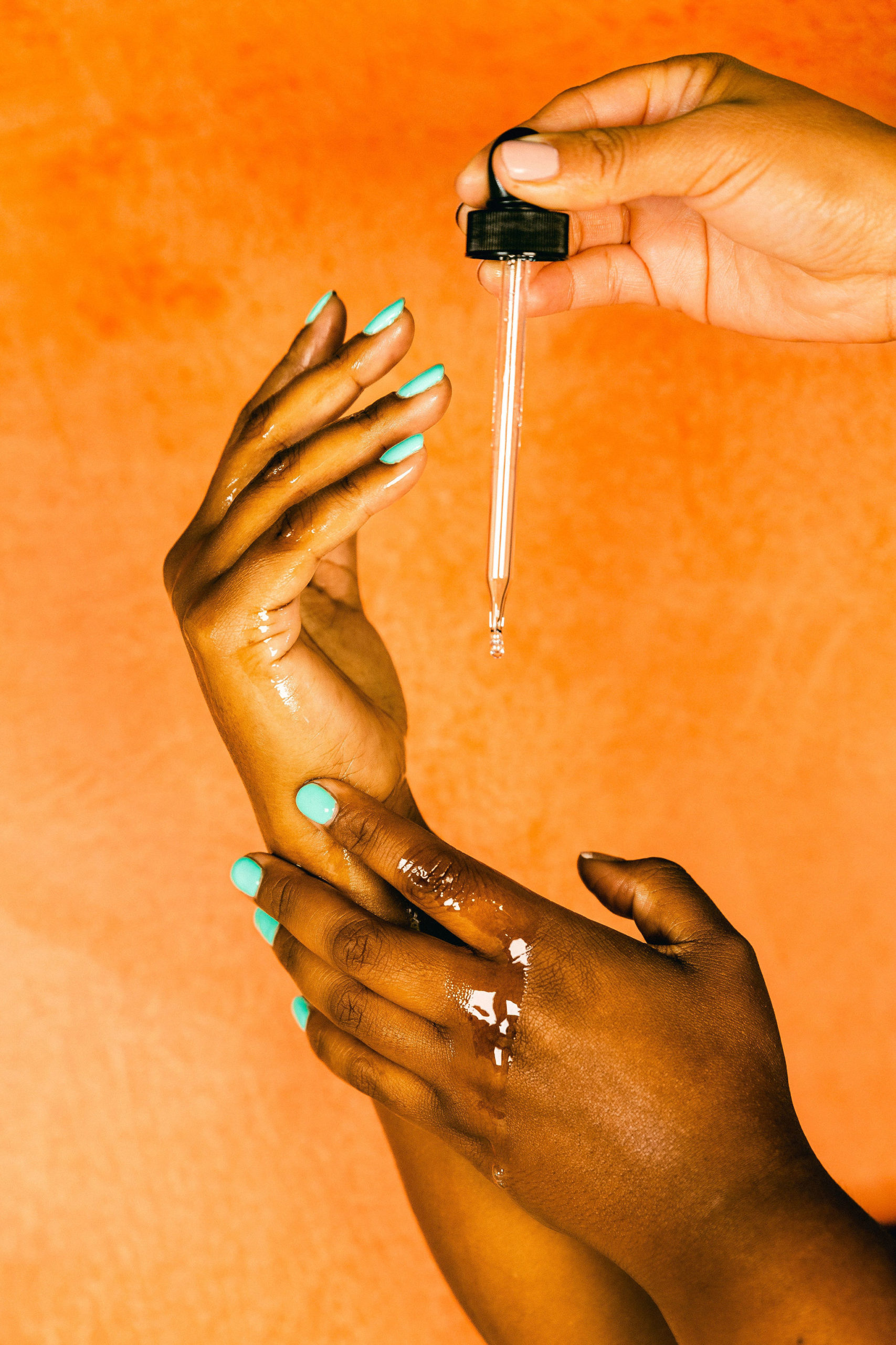 Oil Dropper on hands for skincare product photography black owned small business