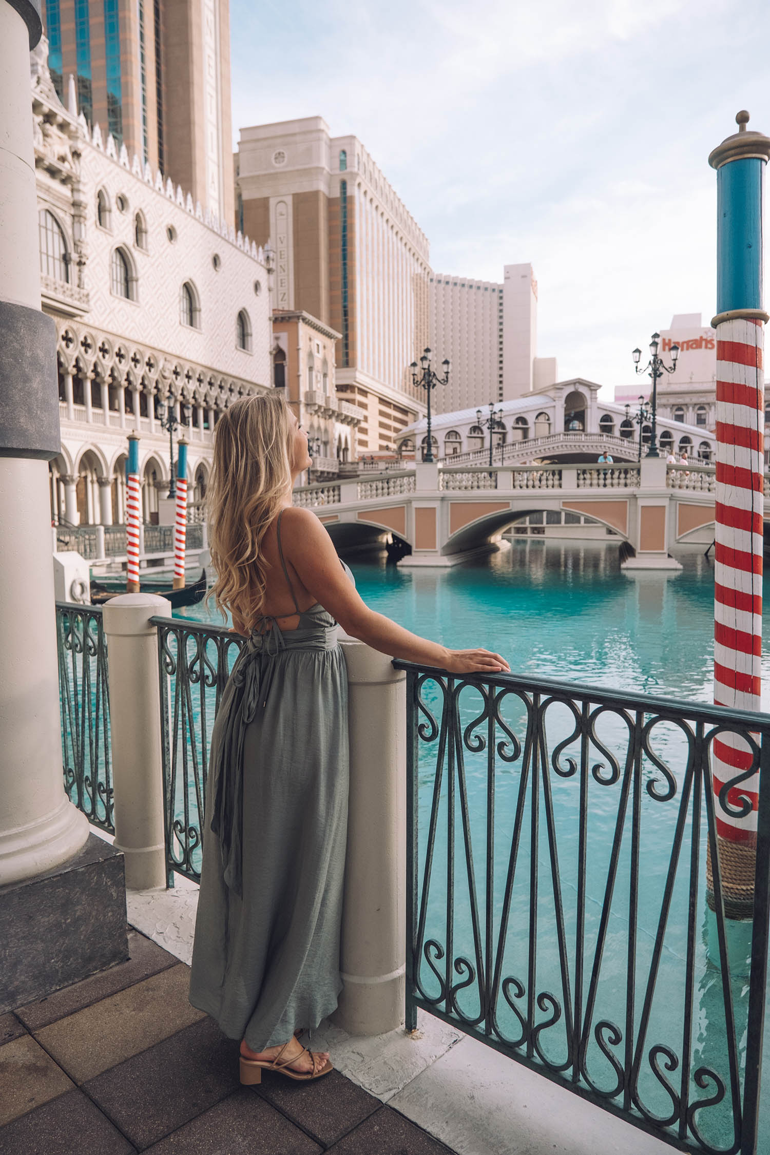 Kiersten Rich Travel Blogger The Blonde Abroad at The Venetian Hotel in Las Vegas posing next to the canals. What to wear in Las Vegas.