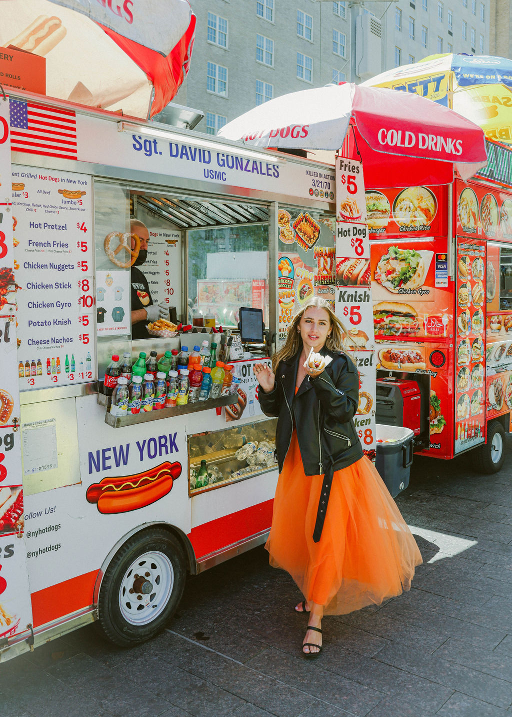 girl in tulle orange dress leather jacket hot dog stand met museum steps