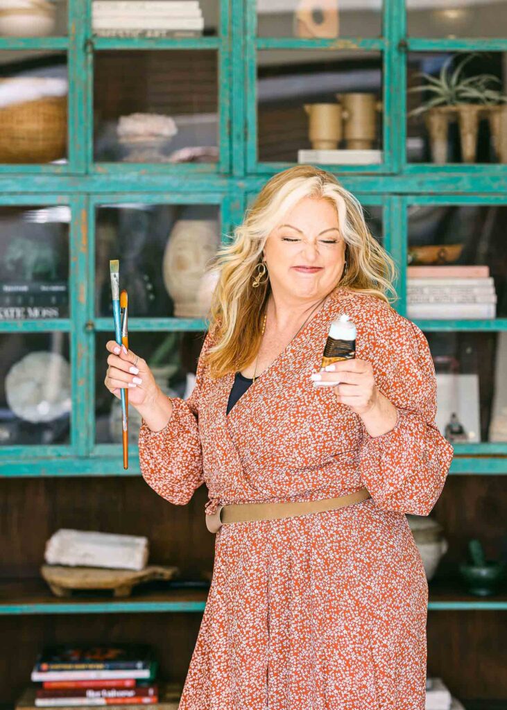 Travel artist brand photography luxury in front of cabinets with paint brushes. Oil painter in home branding photography commercial for magazine. Long Beach, California Chelsea Loren