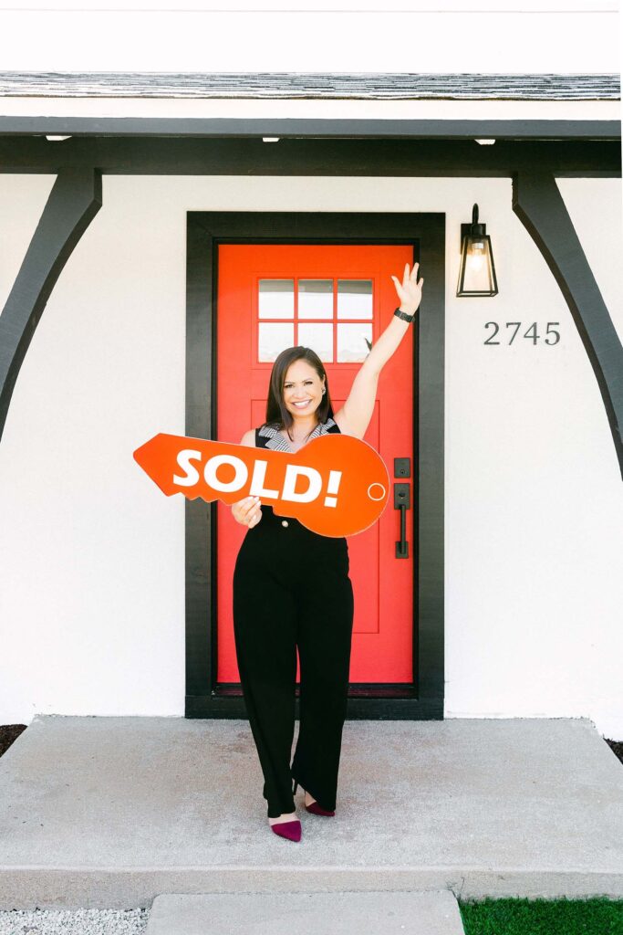 San Diego real estate agent holding up sold sign. Best Personal branding photographer business realtor by Chelsea Loren