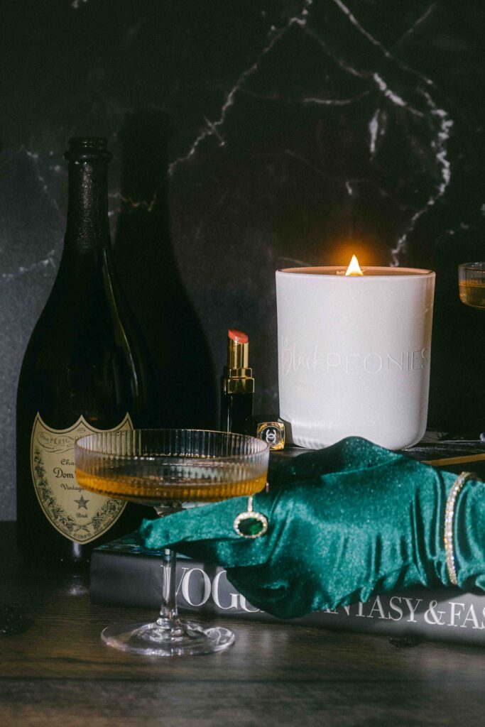 Luxurious styled bougie glamorous old money sophia richie styled product photography for candles vignette black peonies blair waldorf gossip girl new york city ritz champagne