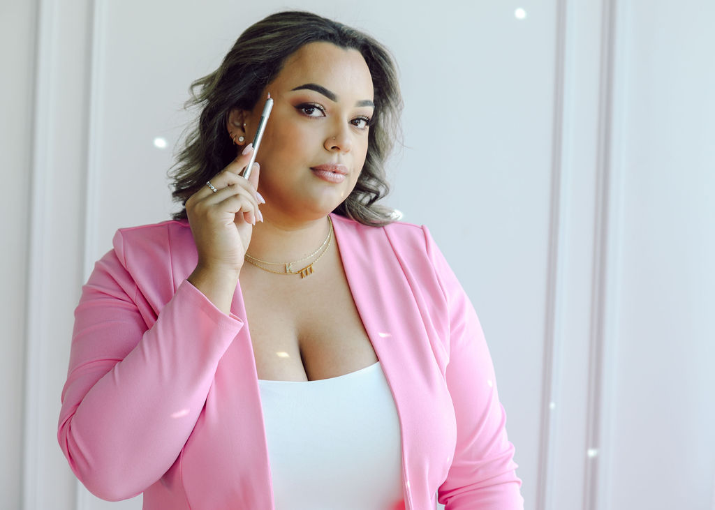 Permanent makeup esthetician boss babe woman powerful and confident in hot pink suit. Joyful personal brand photography