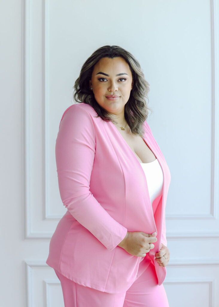 Permanent makeup esthetician boss babe woman powerful and confident in hot pink suit. Joyful personal brand photography