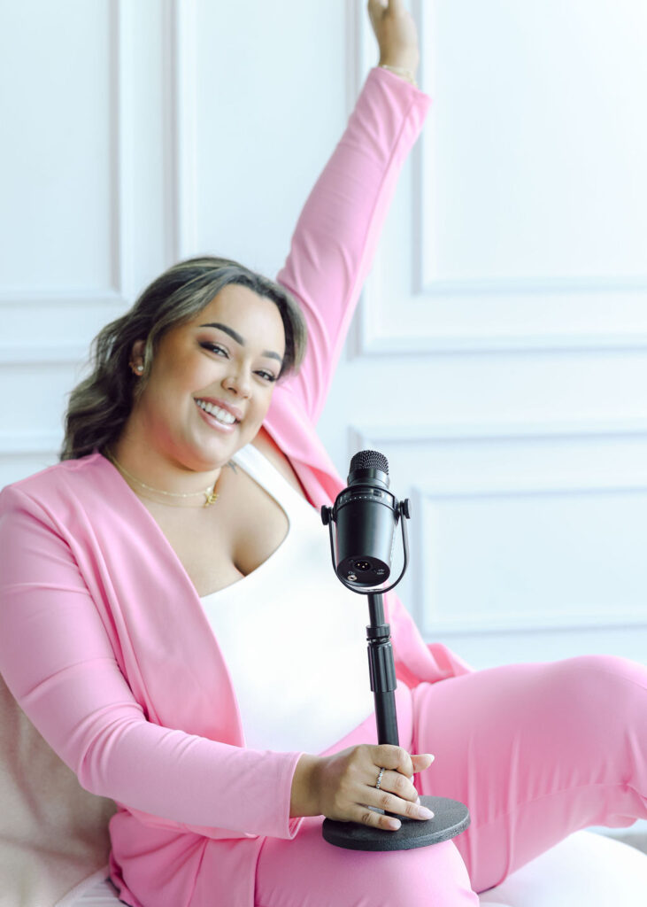 Permanent makeup esthetician boss babe woman powerful and confident in hot pink suit. Joyful personal brand photography podcast photography