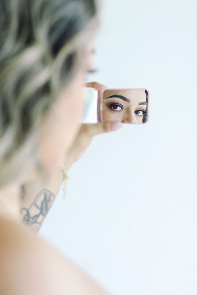 Permanent makeup artist personal branding photos girl looking in mirror creative photography