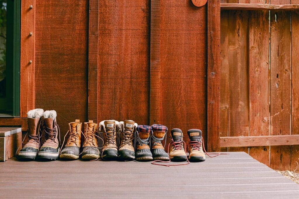 hiking snow boots lined up outside cabin outdoor fashion