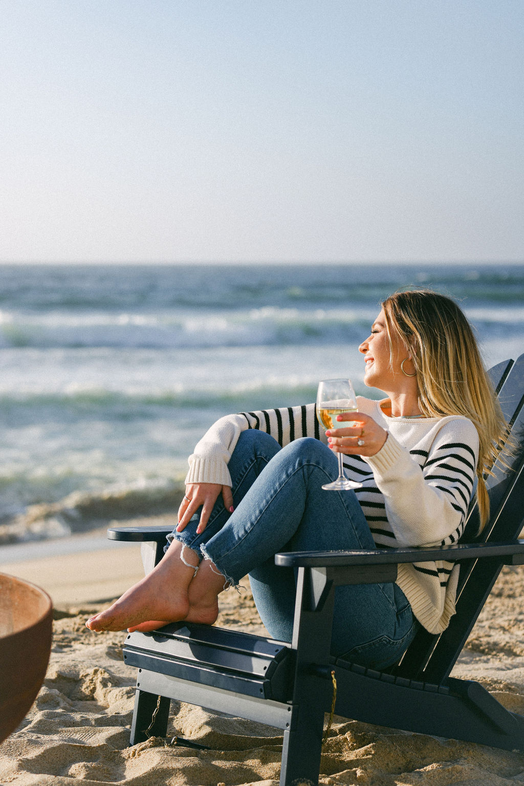 girl drinking glass of wine on beach monterey california - boutique hotel photography adirondack chairs