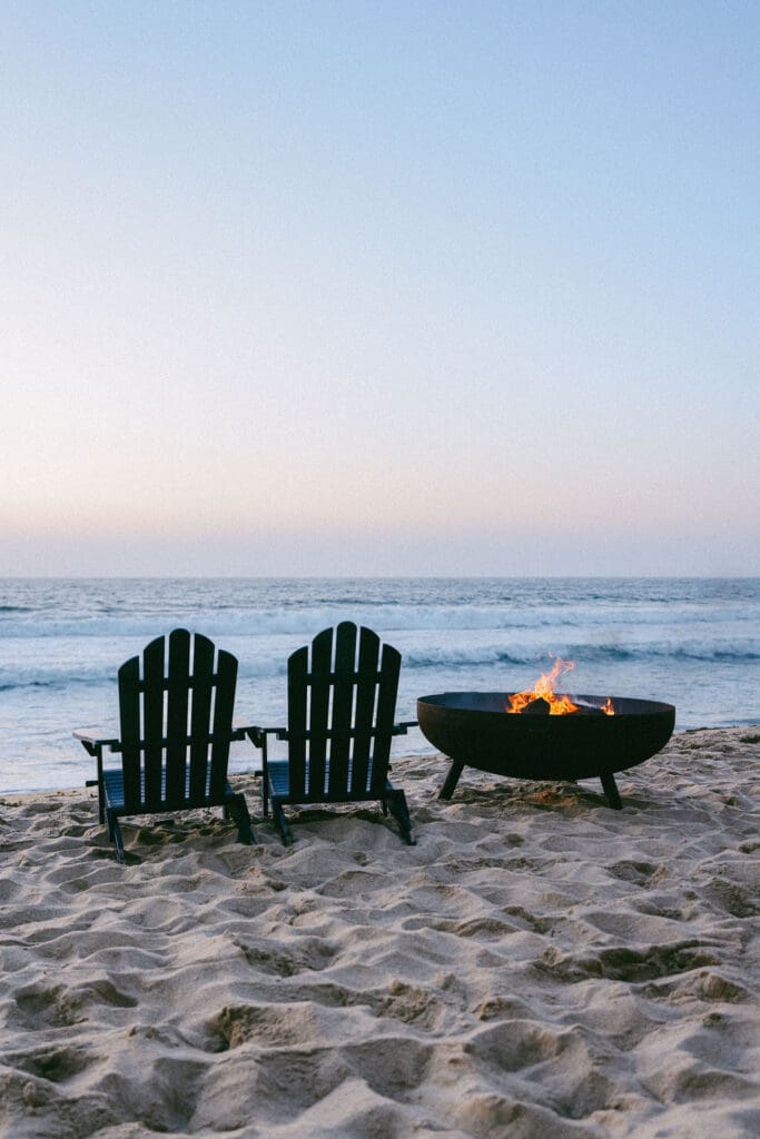 girl drinking glass of wine on beach monterey california - boutique hotel photography adirondack chairs