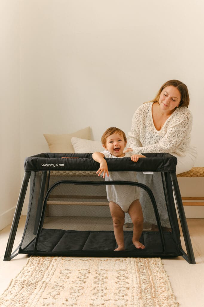 baby playing in travel crib with side zipper luxury commercial kids lifestyle photography