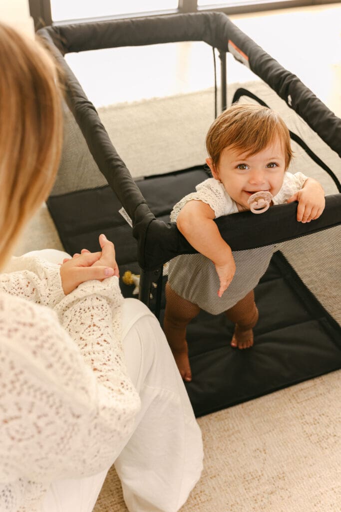 baby playing in travel crib with side zipper luxury commercial kids lifestyle photography