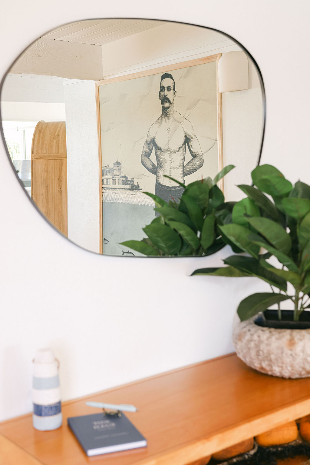 Coastal Low Tide pennant flag and nautical black iron lantern on the teal exterior door of a boutique Airbnb in Carlsbad, California, photographed by Chelsea Loren