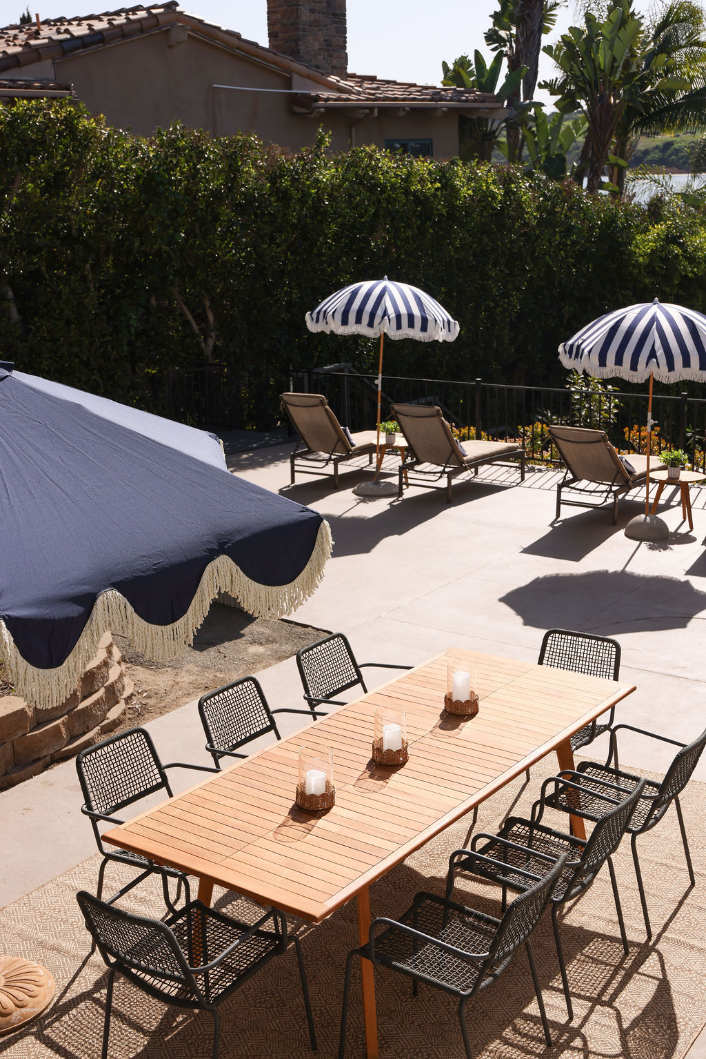 Exterior view of a luxury Airbnb property on the Carlsbad Lagoon waterfront with tropical palm trees in Southern California, photographed by Chelsea Loren