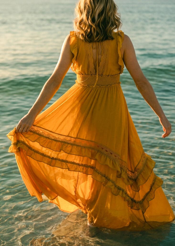 Fashion lookbook photographer creative director golden dress flowing in ocean breeze on California coast | Chelsea Loren Lifestyle Photography