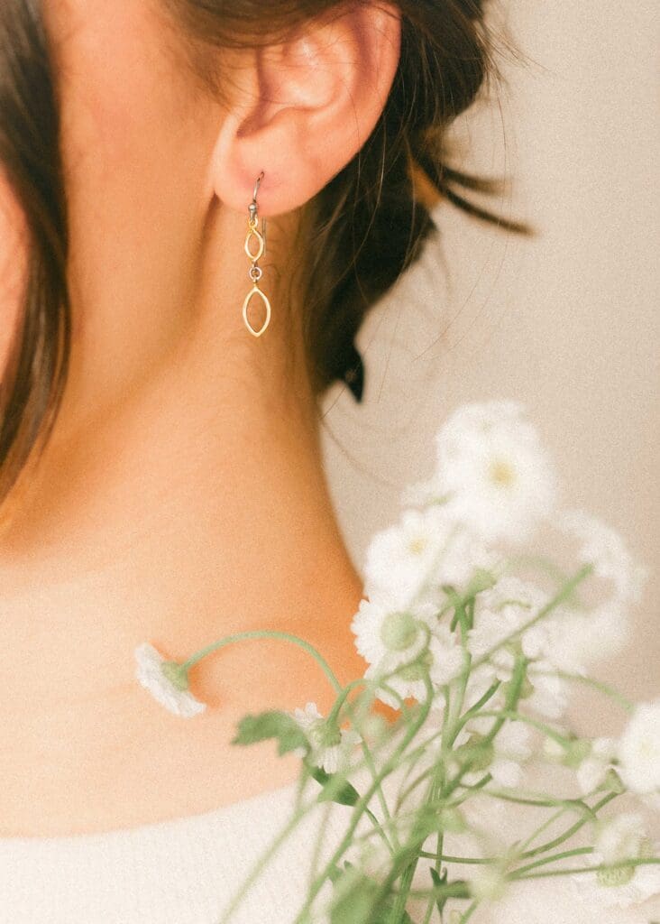 Macro detail fashion photography of gold earring with florals and warm skin tones | Chelsea Loren Lifestyle Lookbook Photographer