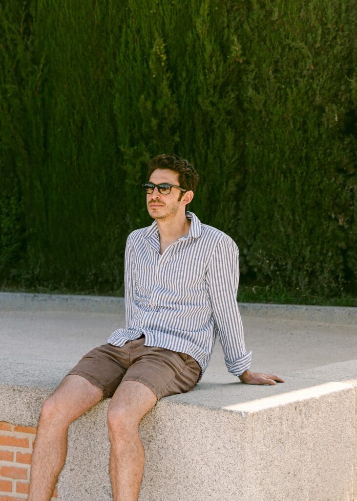 Mens fashion lookbook photo of model in striped linen shirt and sunglasses in architectural setting | Chelsea Loren Creative Director California