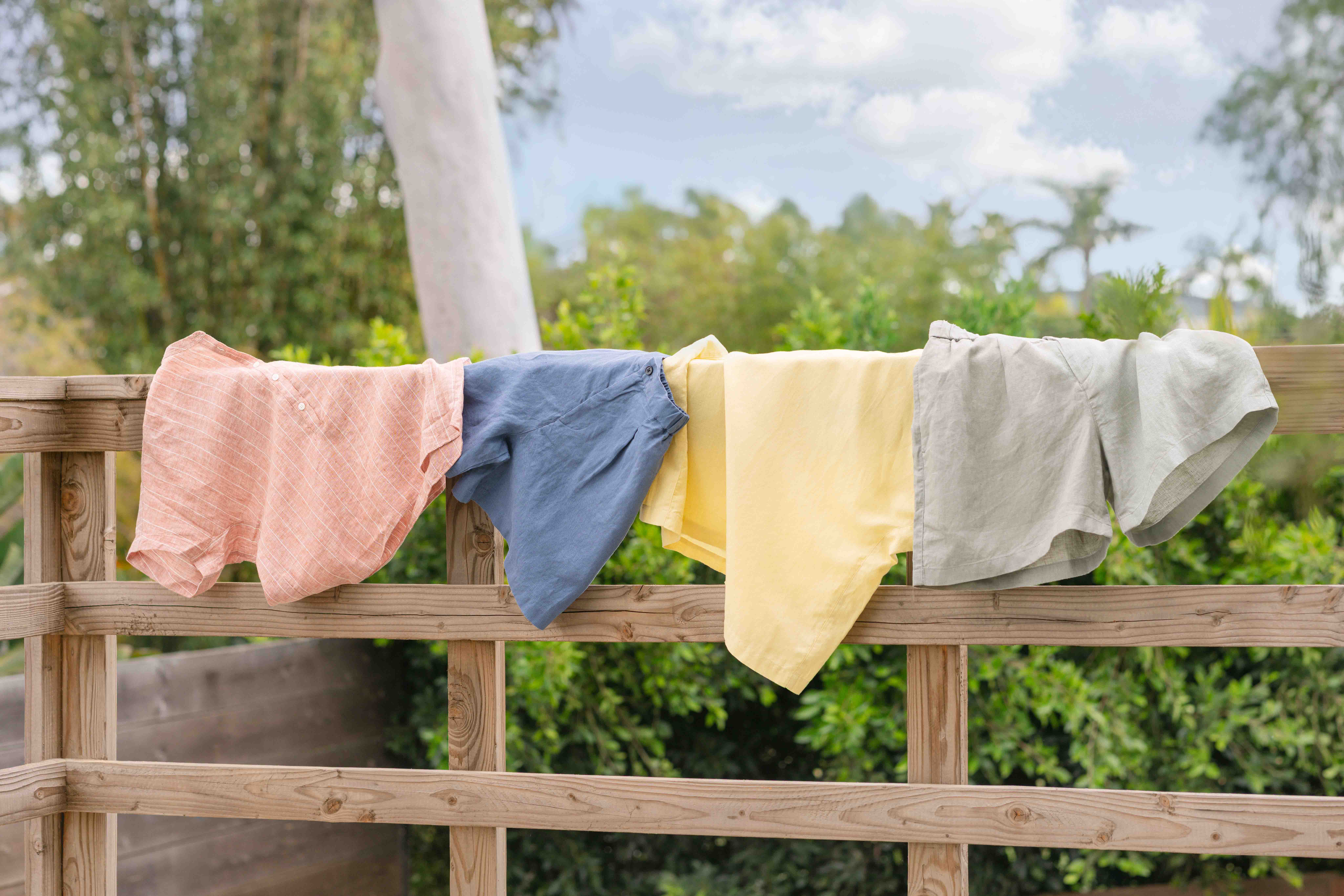 MUJI hemp linen shirts editorial overhead flat lay on weathered wood surface