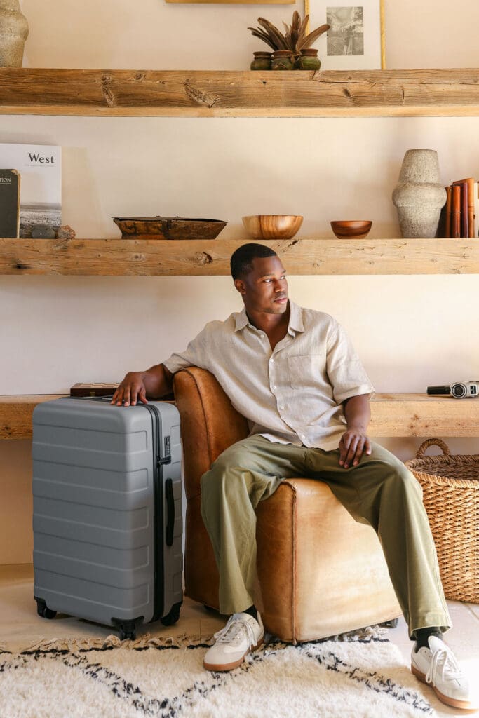 MUJI SS26 hard-shell luggage lifestyle photography – model with MUJI luggage at Carlsbad California shoot, brand photography by Chelsea Loren