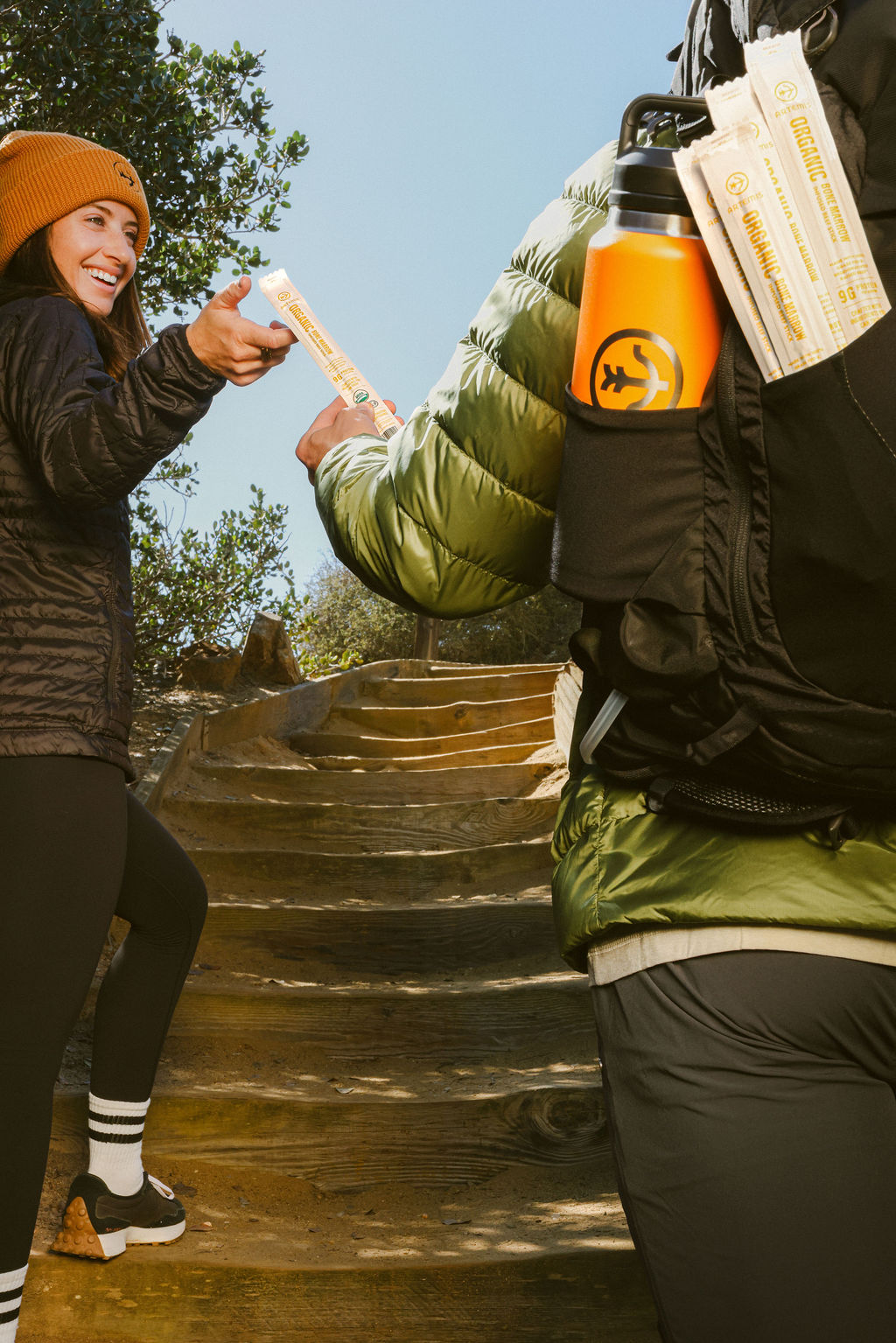 lifestyle brand photography of woman with food product outdoors on San Diego coastal trail