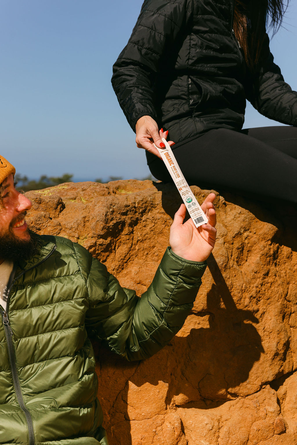 close-up of model holding organic food product on hiking trail for CPG brand content