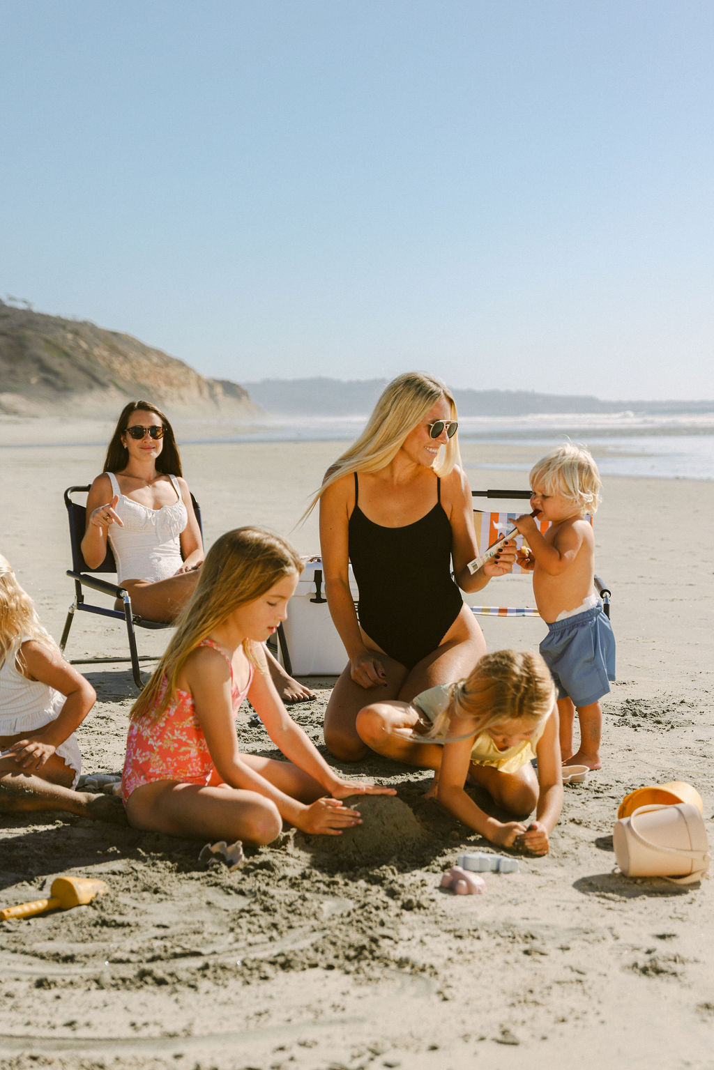 woman on San Diego beach during golden hour lifestyle photography session for CPG food brand