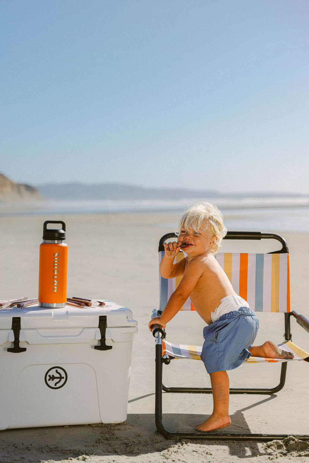 CPG food product styled with water bottle at beach for lifestyle brand content creation