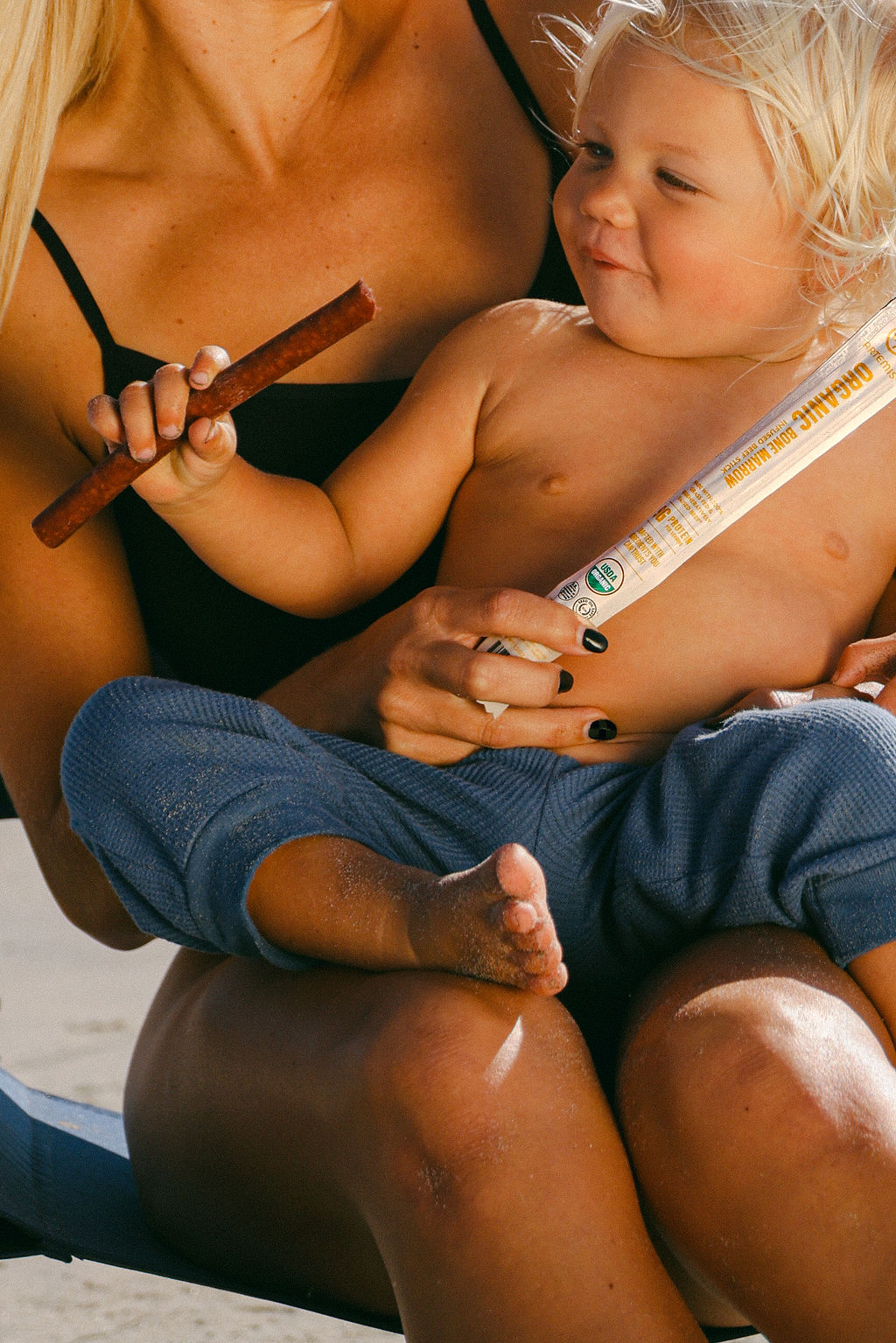 parent and baby with organic food product for family-focused CPG lifestyle brand photography