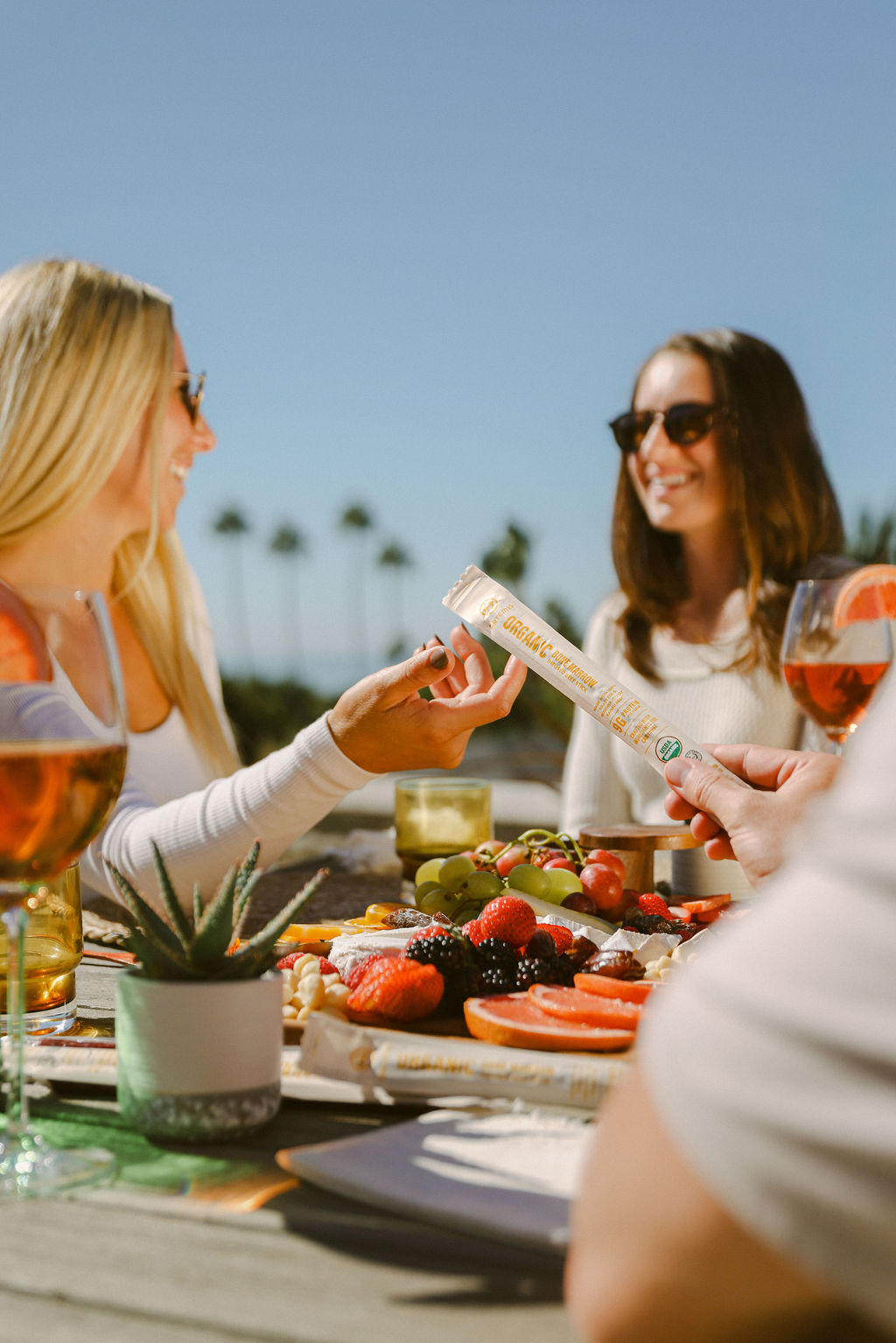 friends socializing at dinner table during lifestyle food brand photoshoot in San Diego home