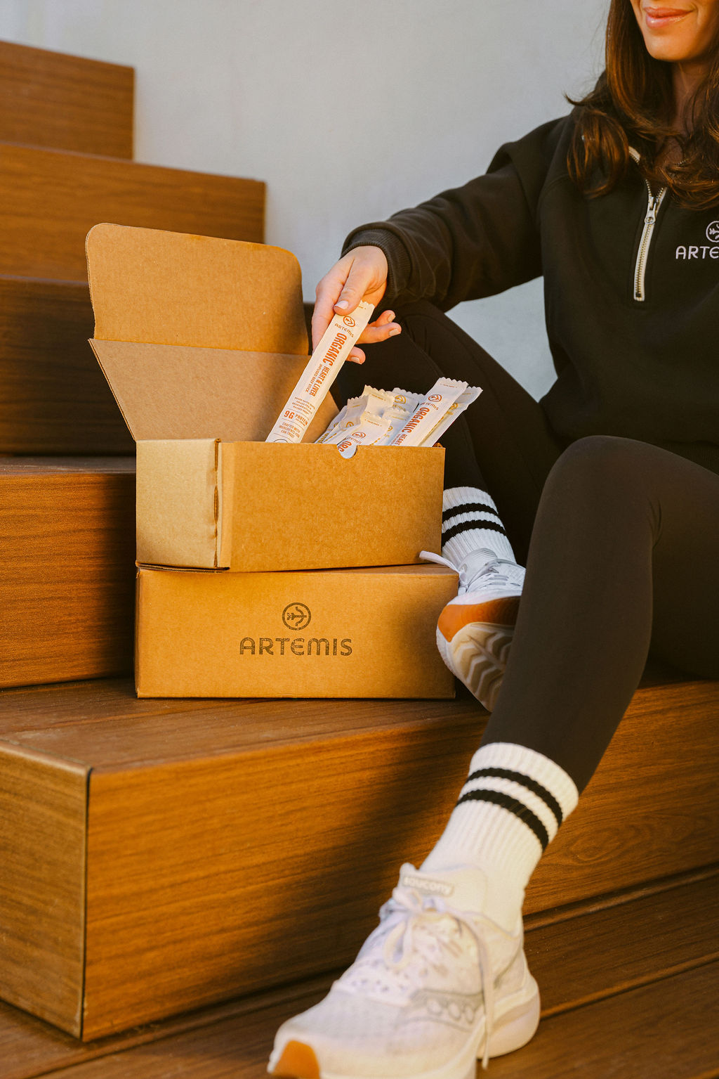 lifestyle photography of model with CPG brand shipping boxes for e-commerce content