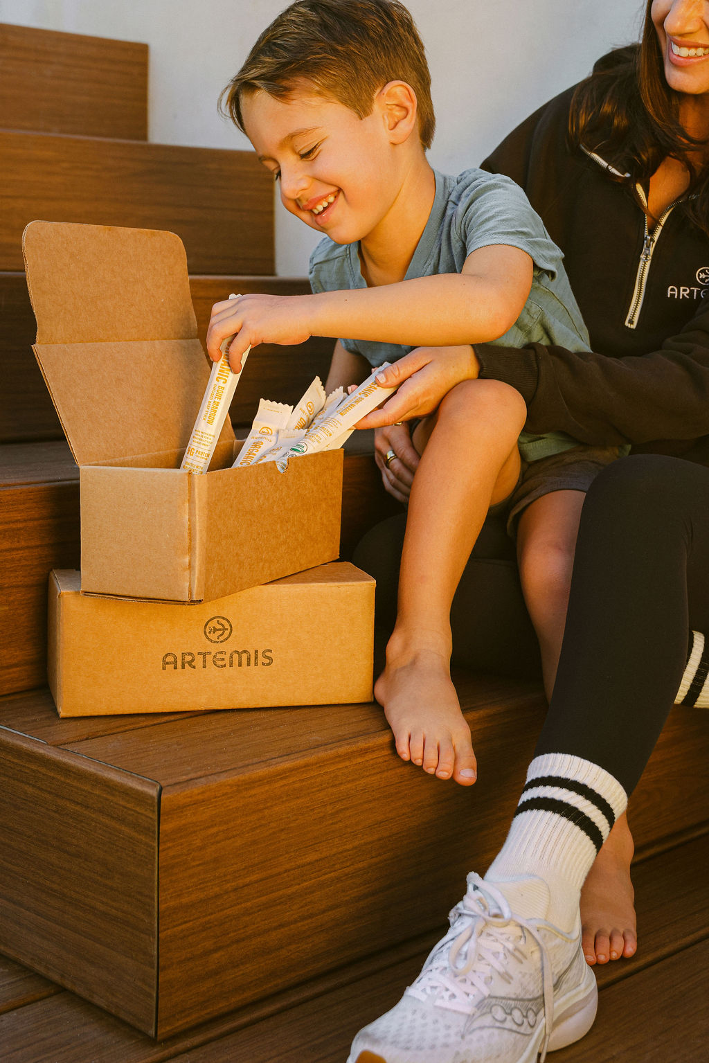 lifestyle unboxing photography showing model opening CPG food brand subscription shipper