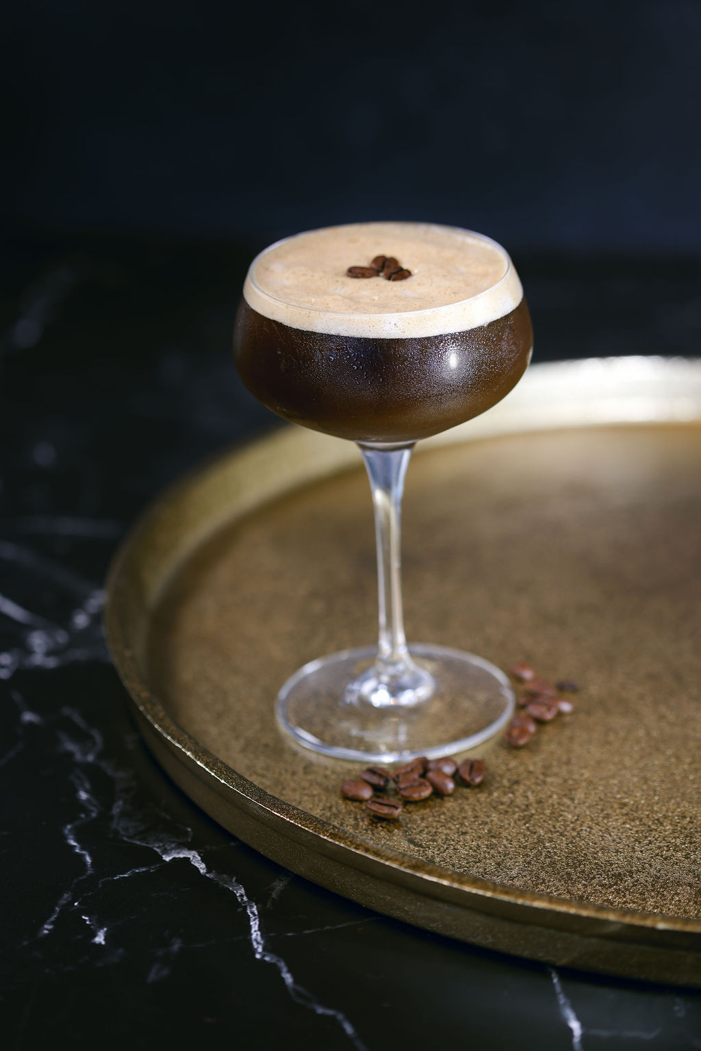 Moody styled cocktail with passionfruit garnish for prohibition-era hotel lounge menu photography by Chelsea Loren