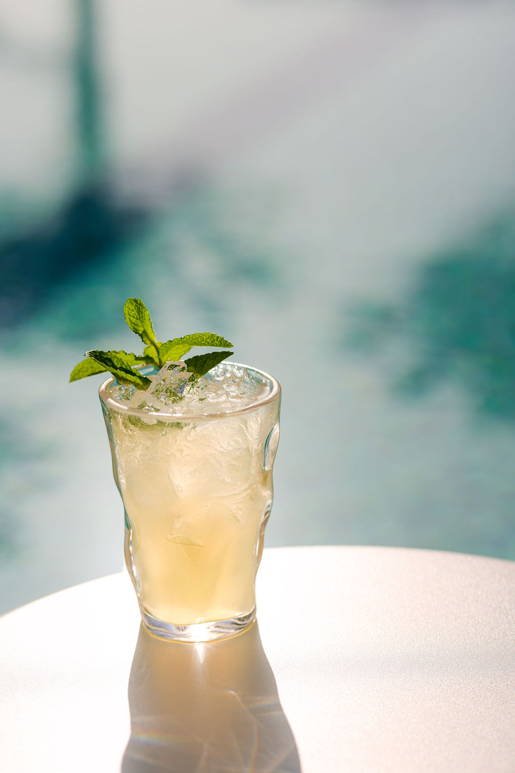 Dramatic styled passionfruit gin sour cocktail on black marble for speakeasy hotel bar photography