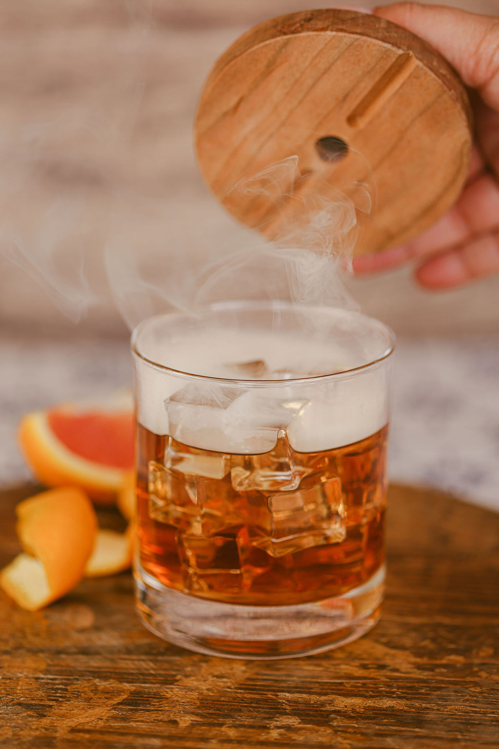 Hands reaching into tiered seafood tower styled for luxury hotel steakhouse menu photography by Chelsea Loren