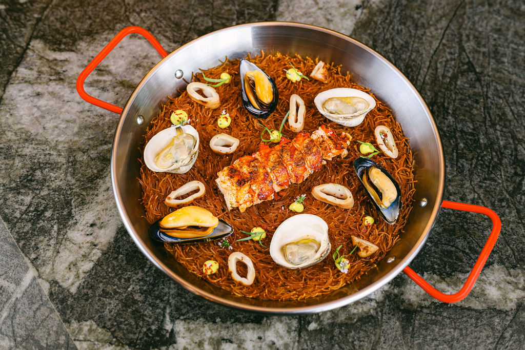 Styled seafood paella in cast iron for luxury hotel restaurant menu photography by Chelsea Loren San Diego