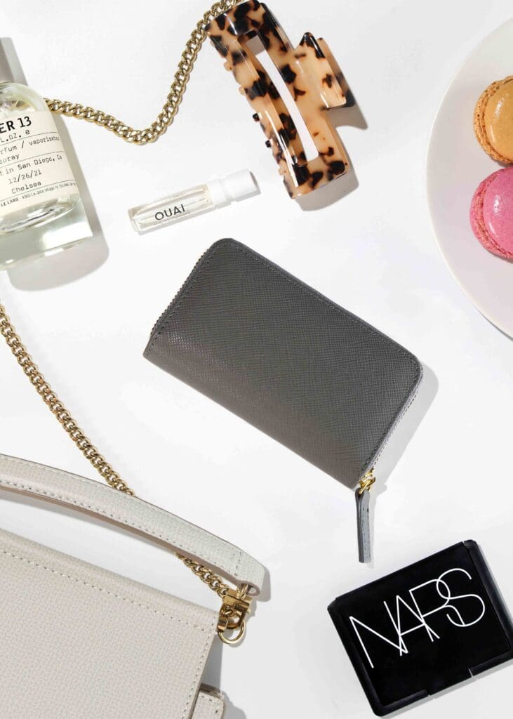 Empowered Co leather card holder wallets styled on Architectural Digest book with peonies and macarons